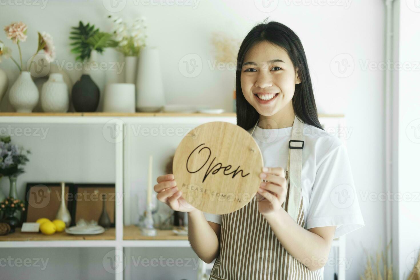 Young asian business owner turning open sign product store and ready to service for welcome the customer. photo