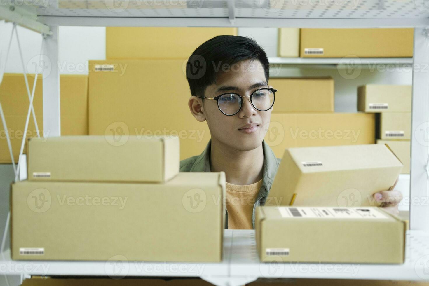 Online store owner checking orders for packaged product. photo