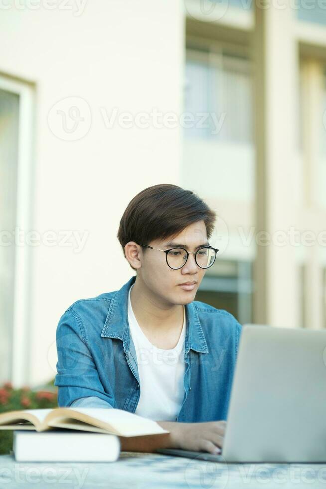 Student studying outdoor using laptop. photo