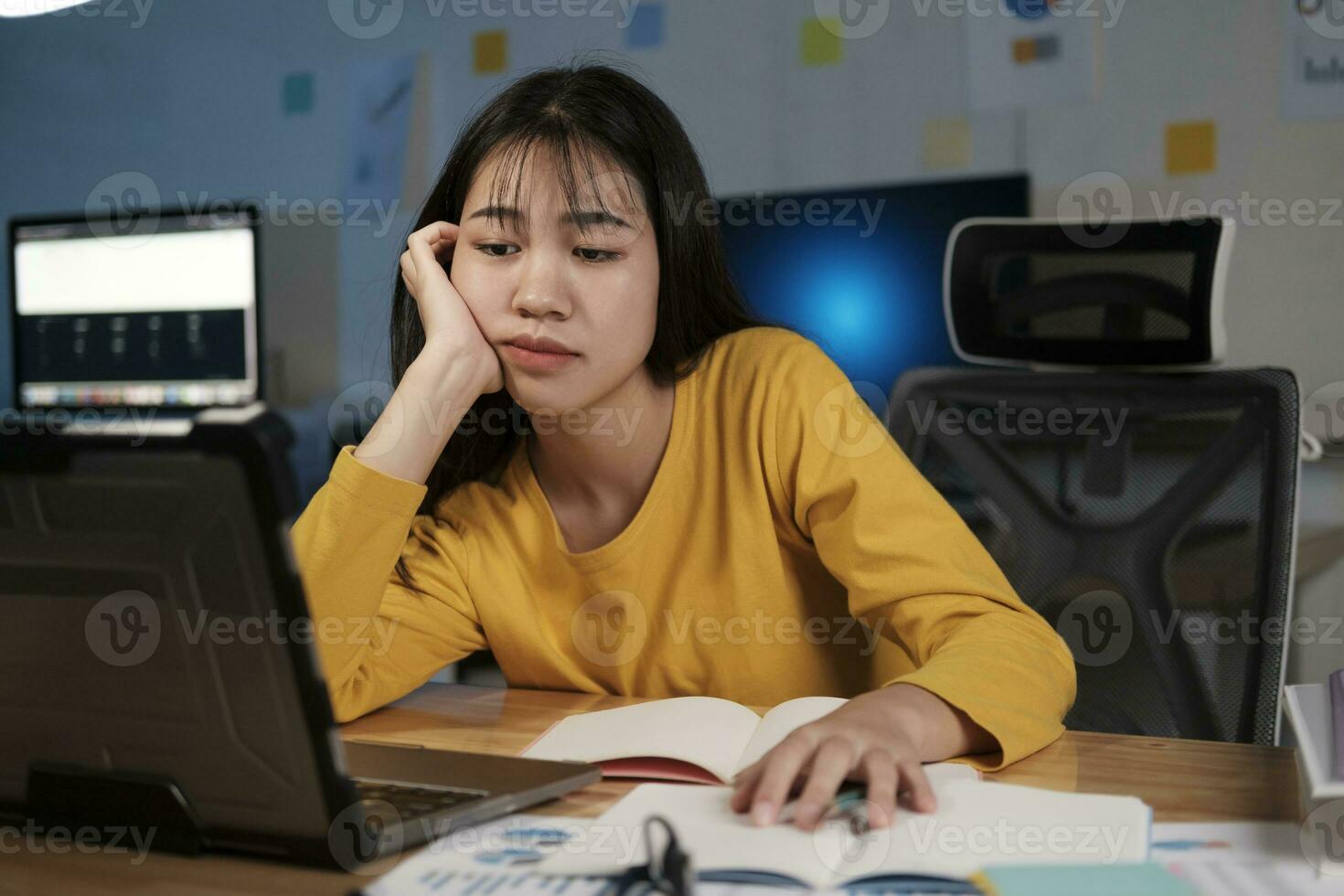 Young woman working on laptop in the office photo