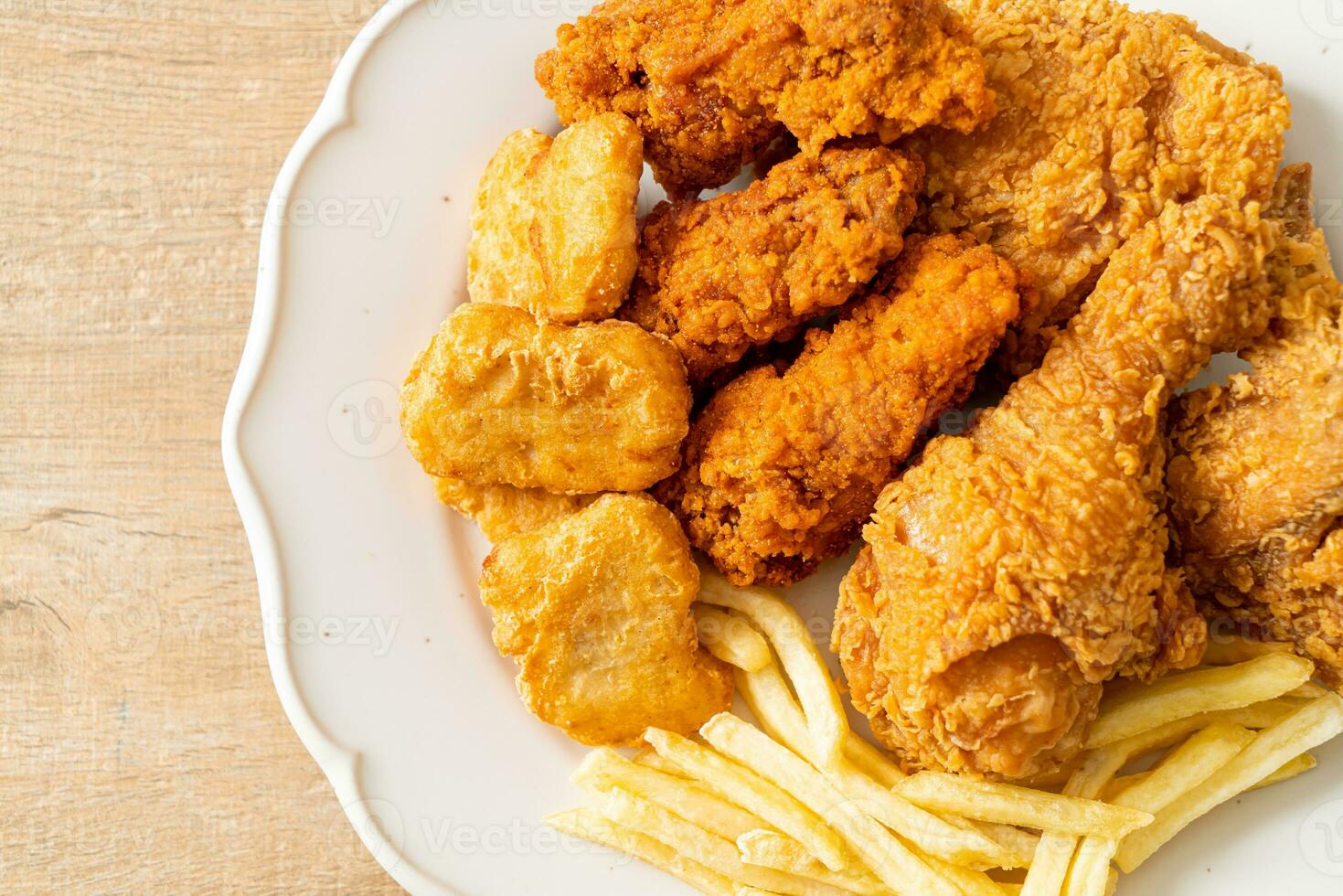 fried chicken with french fries and nuggets on plate photo