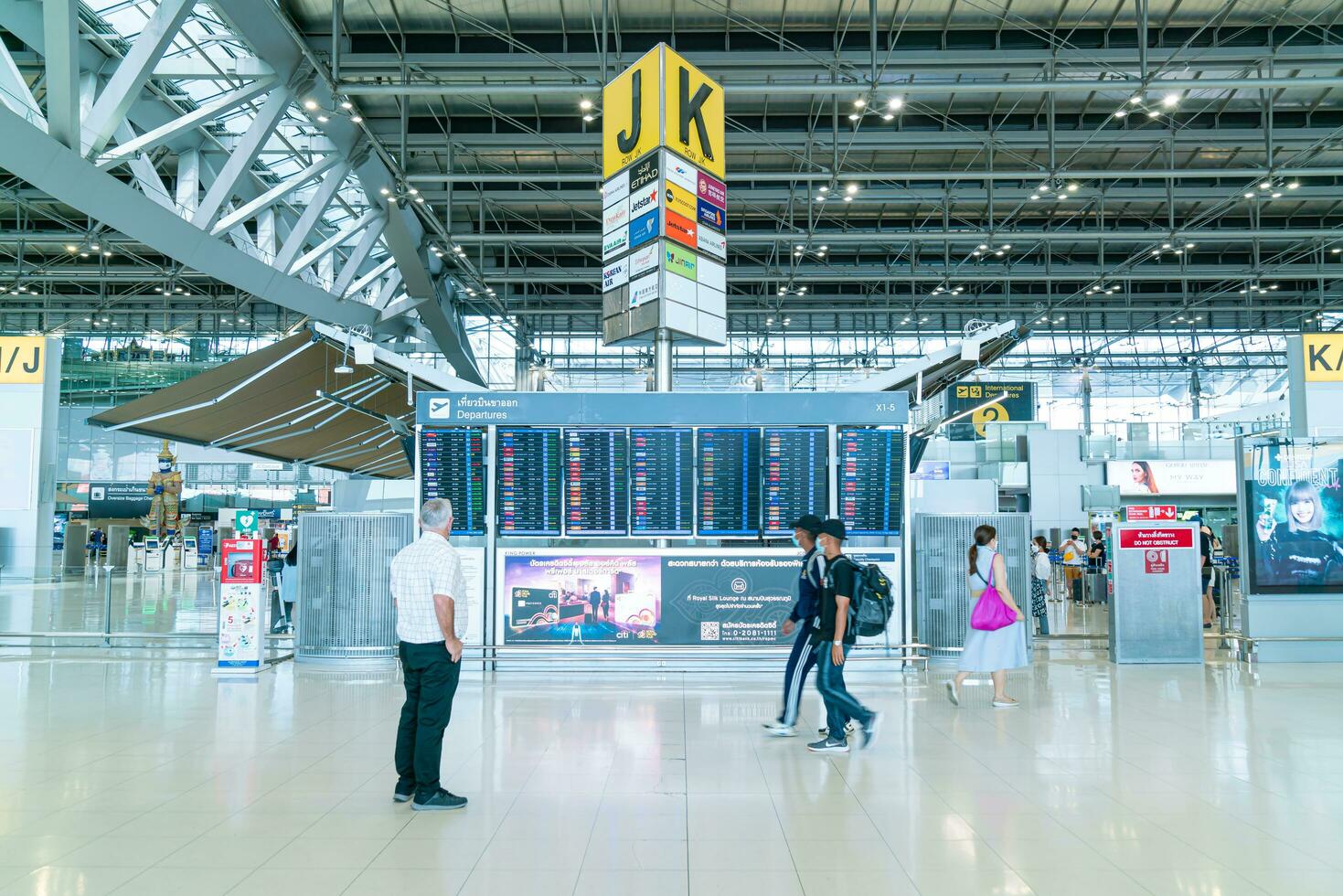 Bangkok, Thailand - May 23, 2022 - Bangkok Suvarnabhumi airport passengers inside the departure terminal, people in medical masks from coronavirus. photo