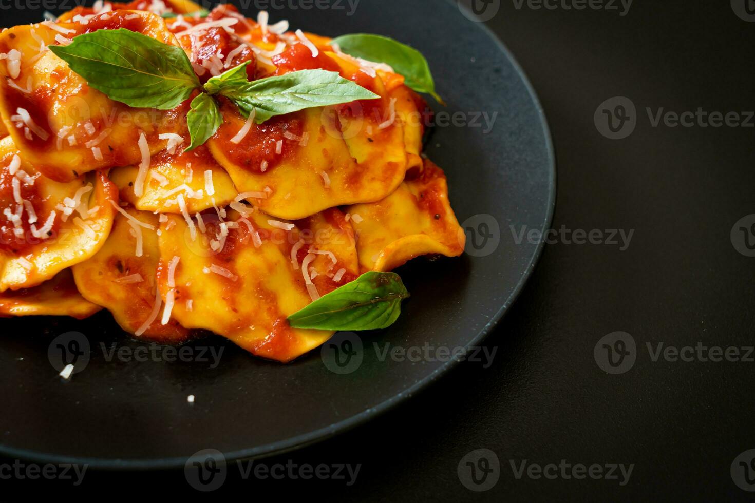 Ravioli with tomato sauce and basil photo