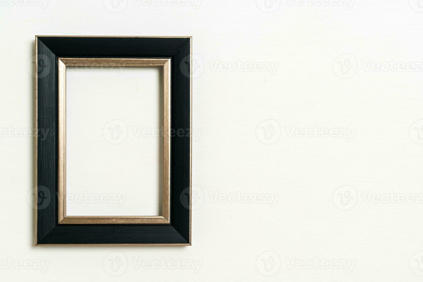 empty picture frame on white wall background photo