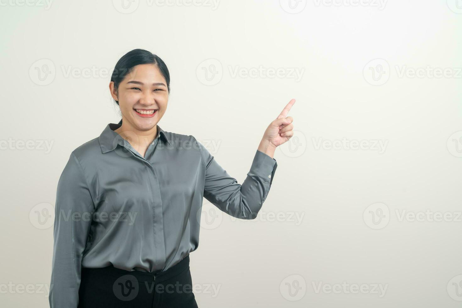 Asian woman with hand pointing on white background photo