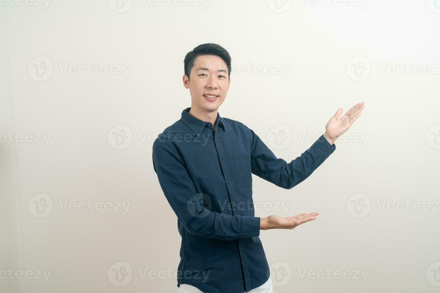 Asian man with hand pointing or presenting on white background photo