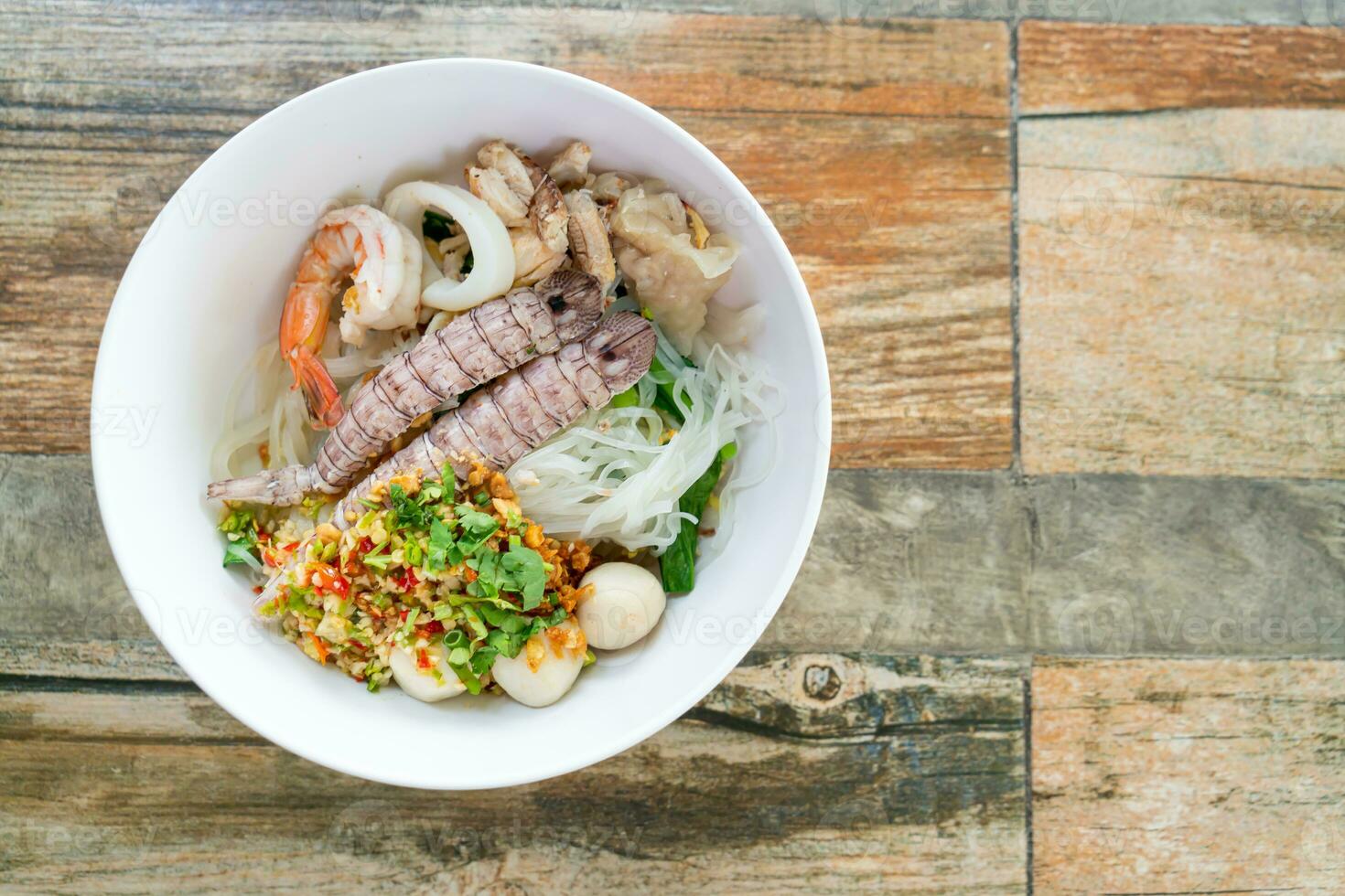 spicy seafood noodles bowl in Thai style photo