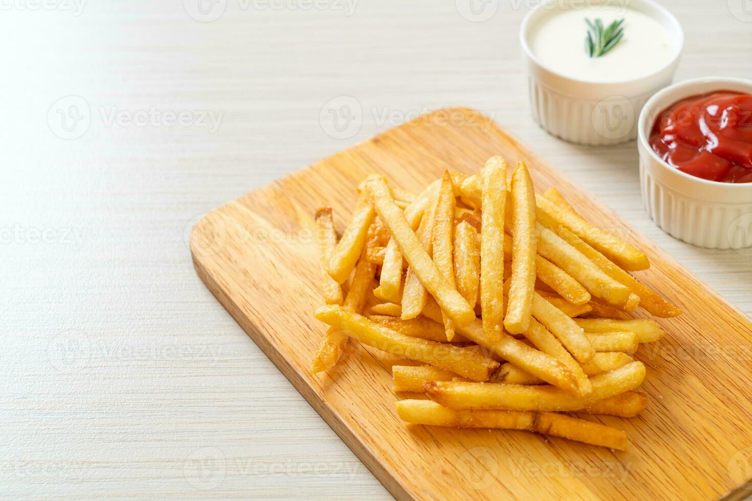 French fries with sour cream and ketchup photo