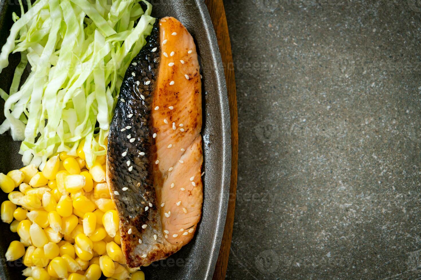 grilled salmon fillet steak on hot plate photo