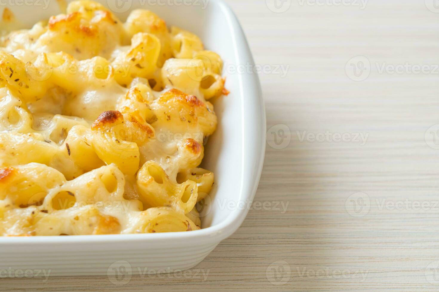American mac and cheese, macaroni pasta in cheesy sauce photo