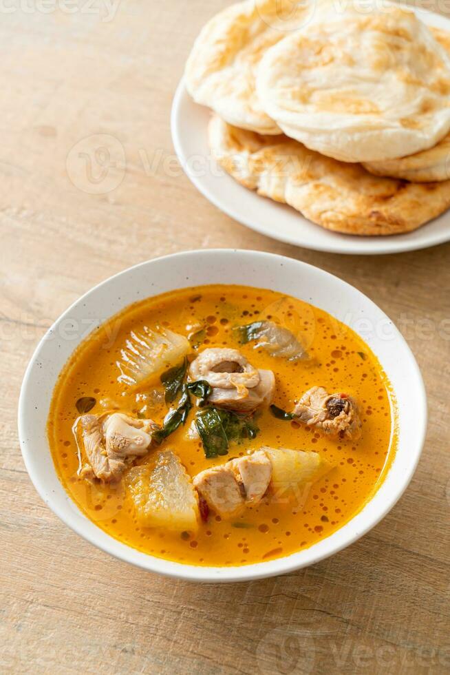 Chicken curry soup with roti photo