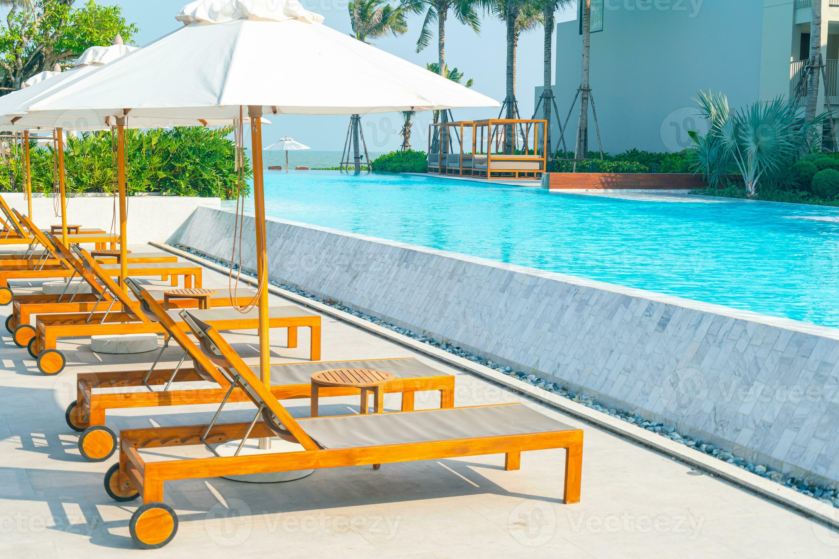 umbrella with bed pool around swimming pool with ocean sea background