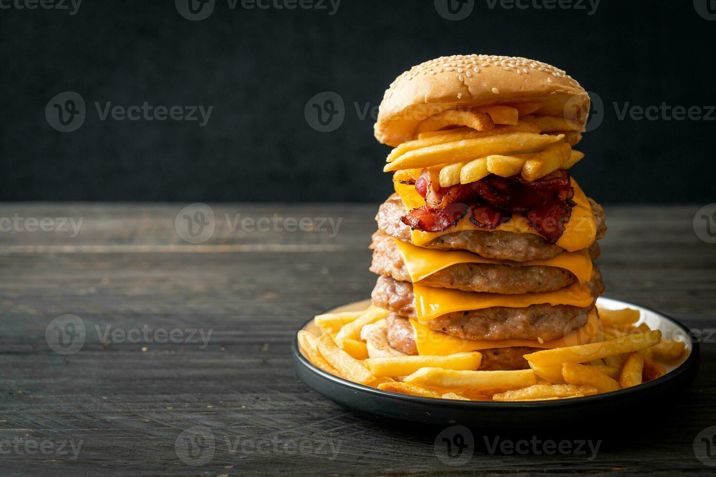 pork burger with cheese, bacon and french fries photo