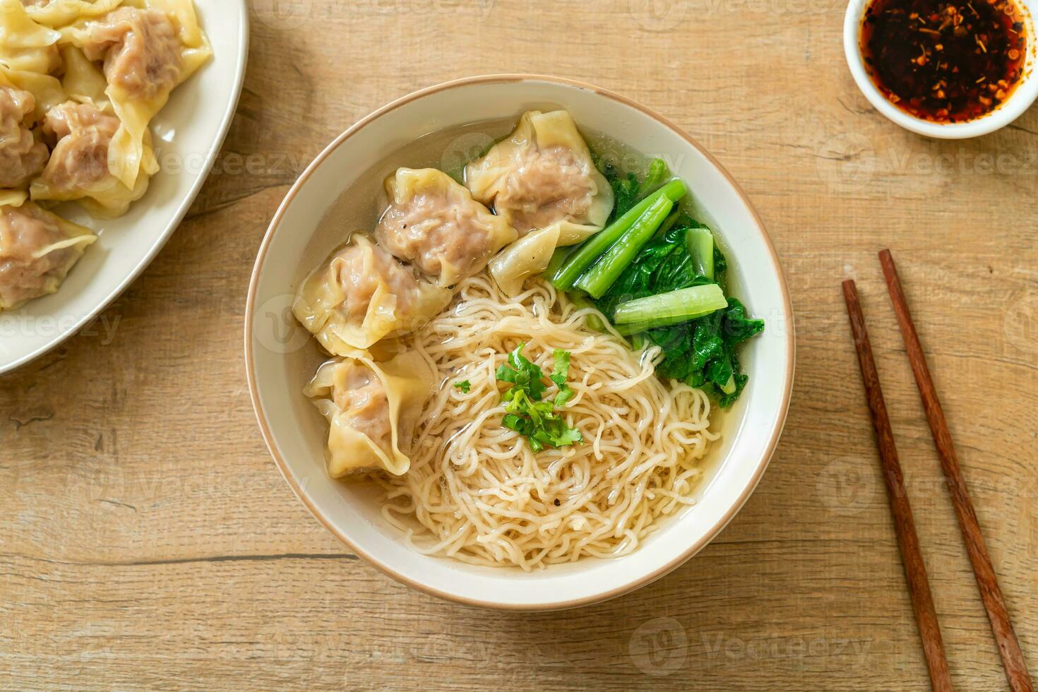 egg noodles with pork wonton soup or pork dumplings soup and vegetable photo