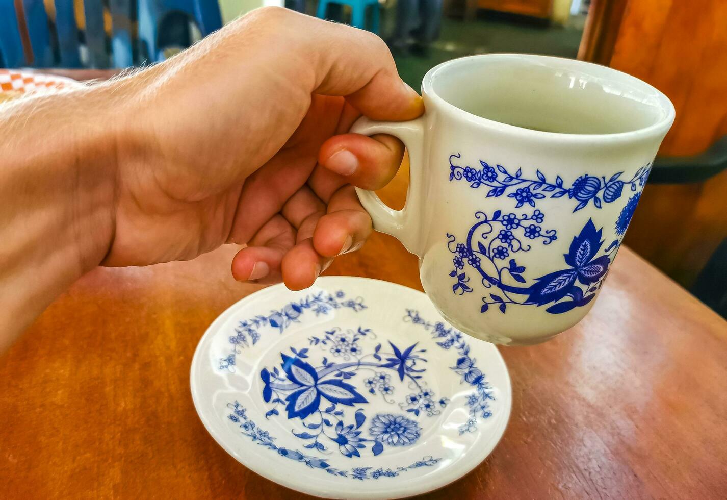 Blue white cup pot with black coffee wooden table Mexico. photo