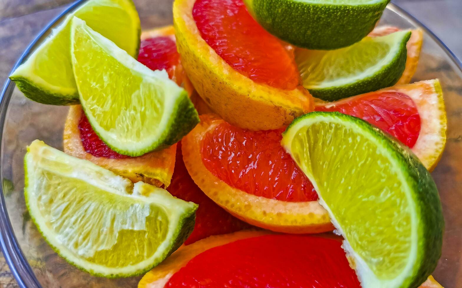 Oranges limes grapes lemon citrus grapefruit fruits on plate Mexico. photo