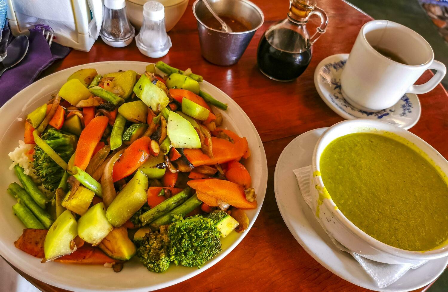 Green vegetable cream soup and vegetable fruit salad in Mexico. photo