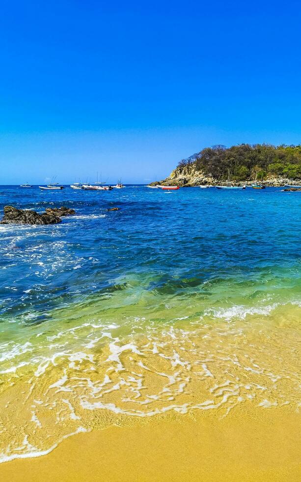 Beach sand blue turquoise water waves rocks panorama Puerto Escondido. photo