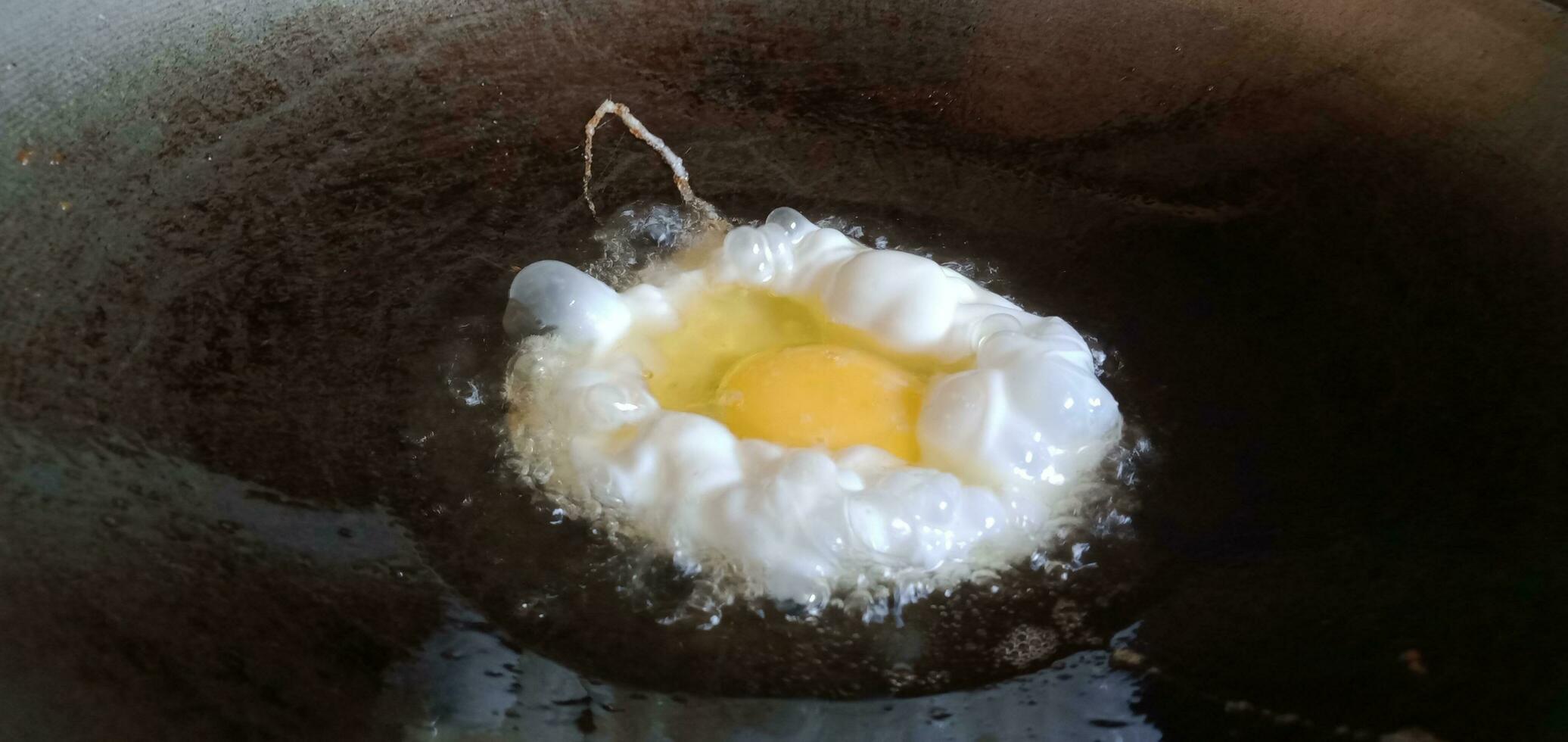 Scrambled Eggs Being Fried in a Frying Pan photo