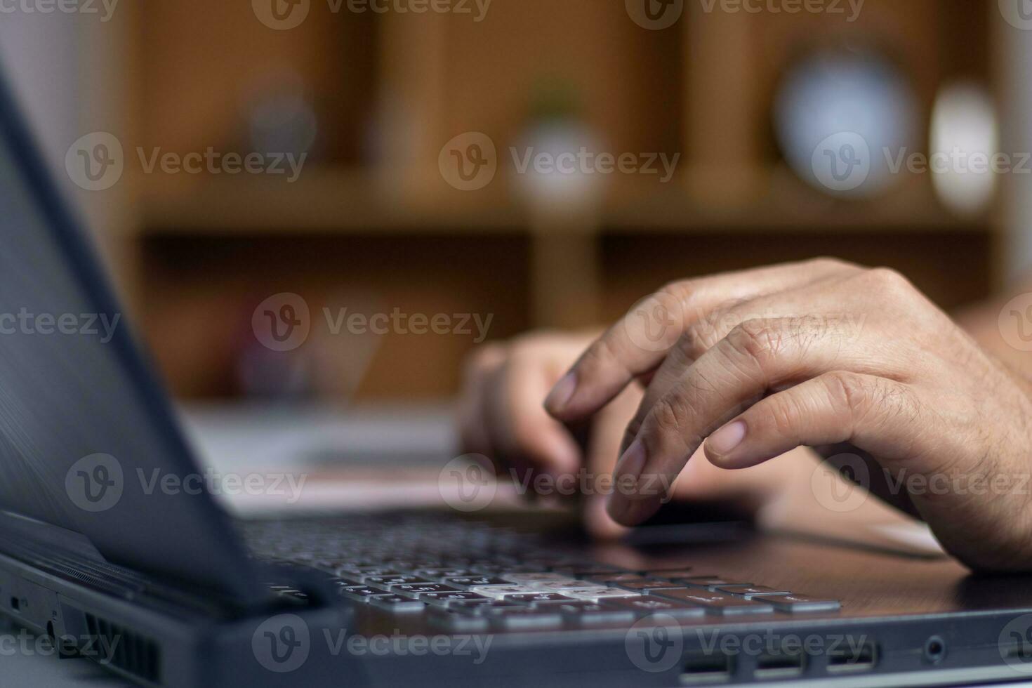 Male hands typing on laptop keyboard and surfing internet on desk, business concept and technology, internet network communication photo