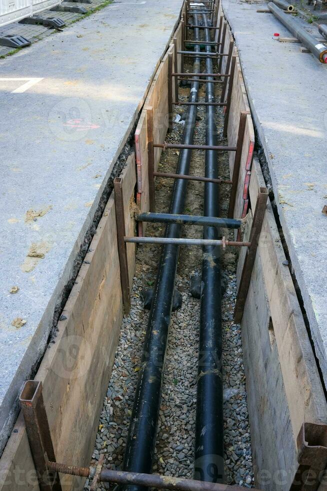 Construction site, manhole for pipes in the street photo