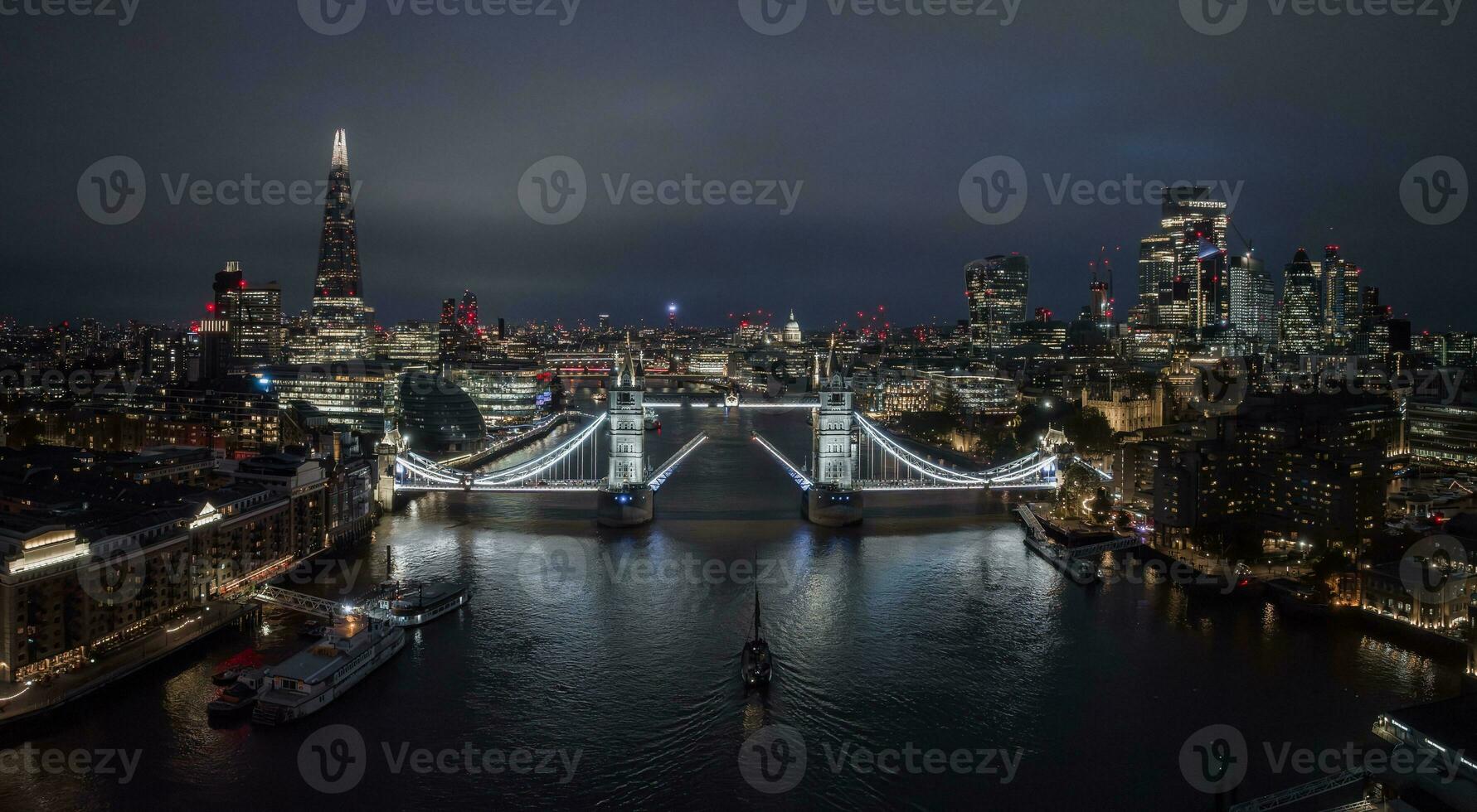 Aerial night view of the lifting up Tower Bridge in London. photo