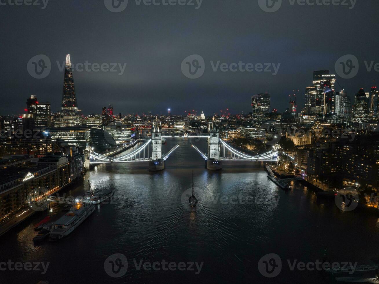 Aerial night view of the lifting up Tower Bridge in London. photo