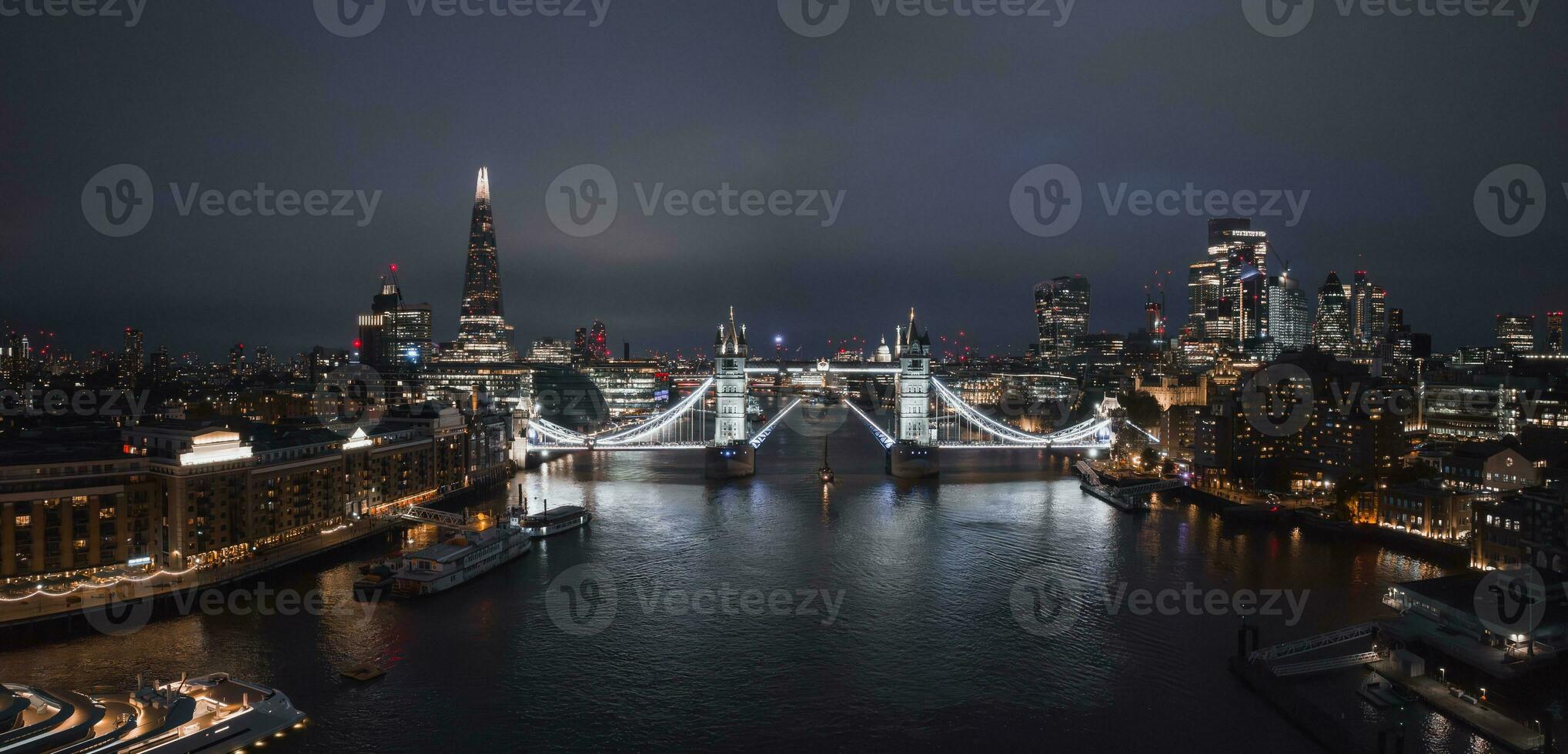 Aerial night view of the lifting up Tower Bridge in London. photo