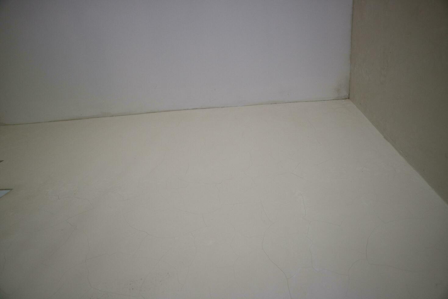 a corner of the wall of a room with white paint photo