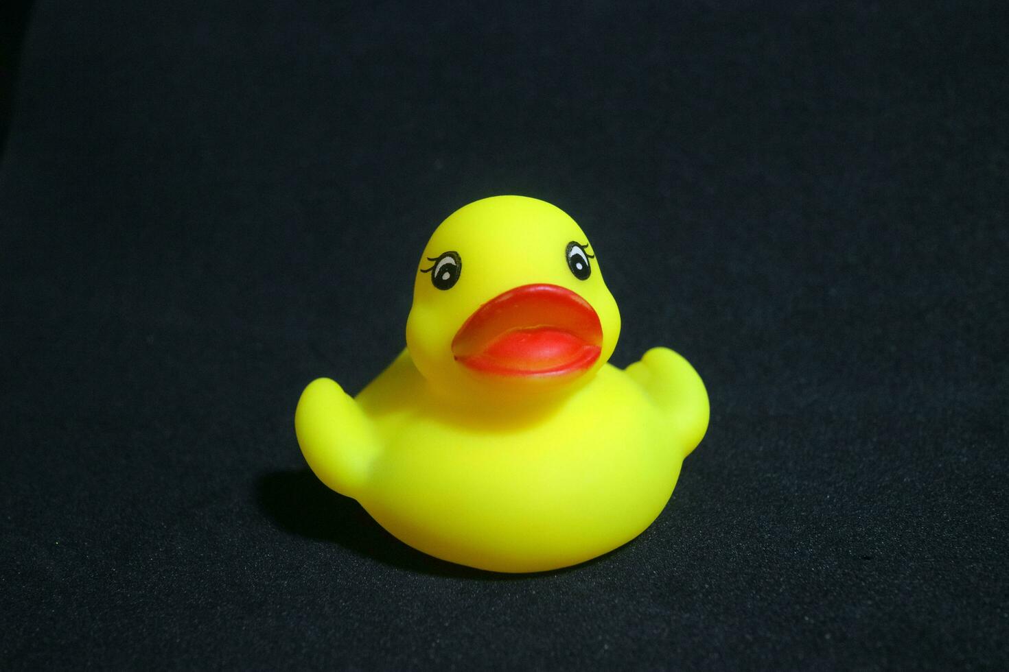 Cute little yellow toy duck with red lips photo