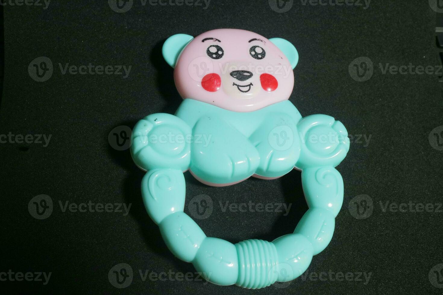 Pink blue baby holding toy with clown face photo