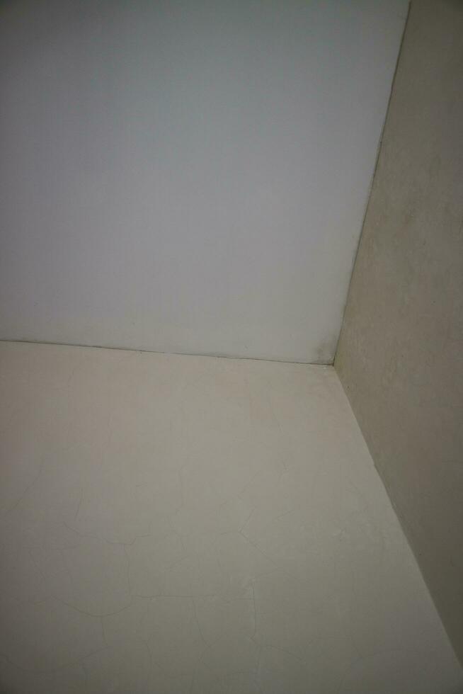 a corner of the wall of a room with white paint photo