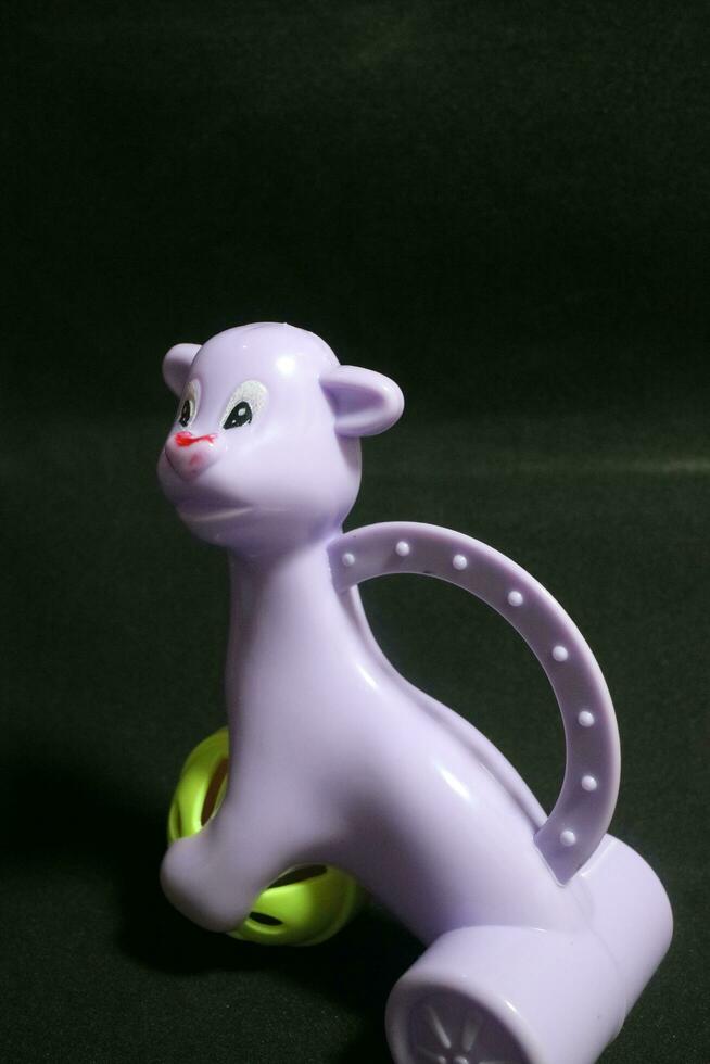 Cute purple alpaca toy holding a ball photo