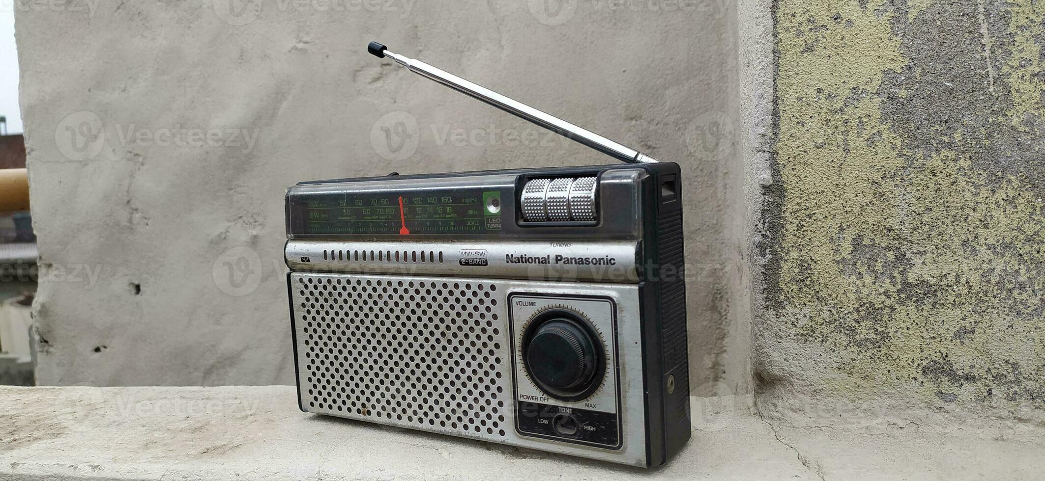 An old silver black radio that is broken photo