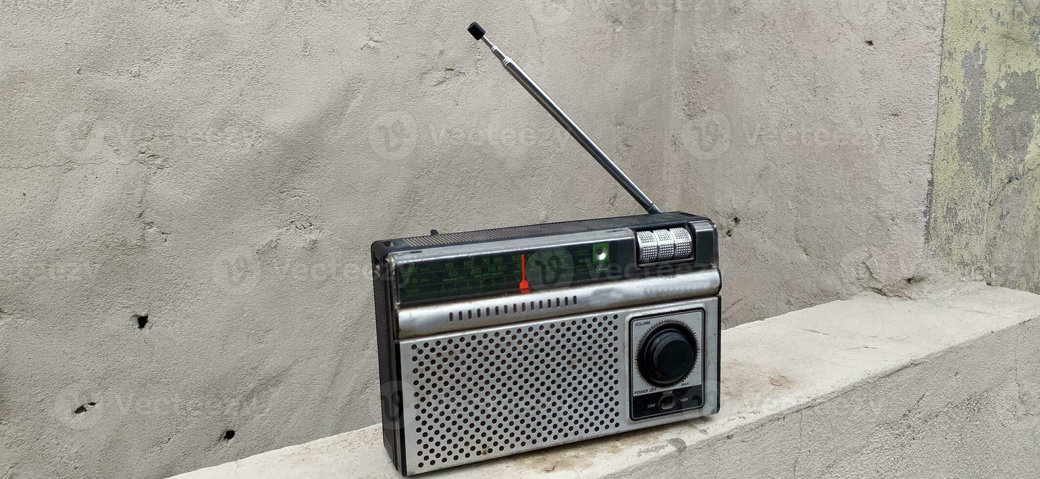 An old silver black radio that is broken photo