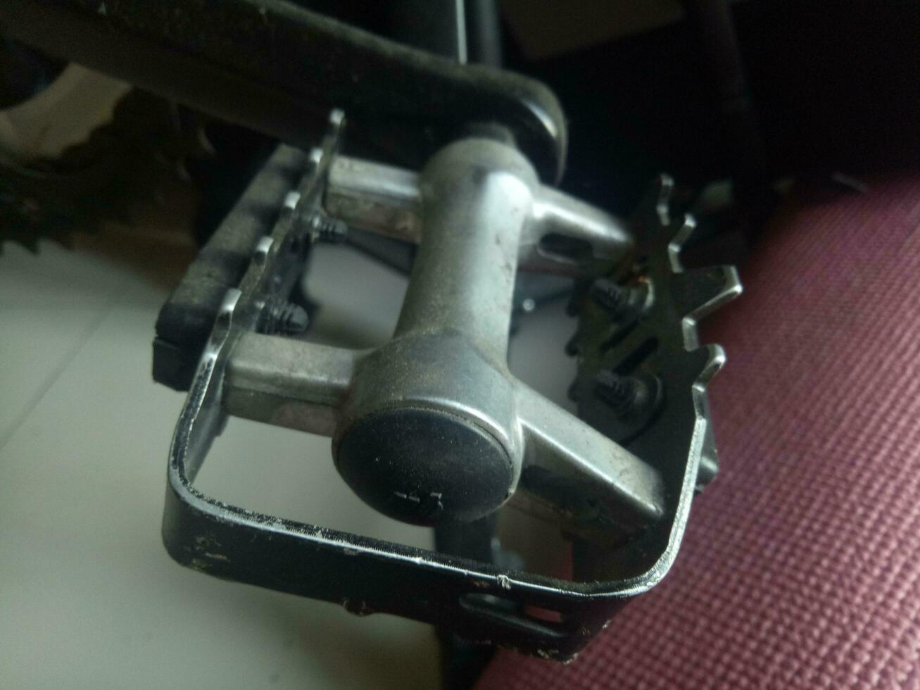 Photo of a bicycle pedal crank made of aluminum in black color