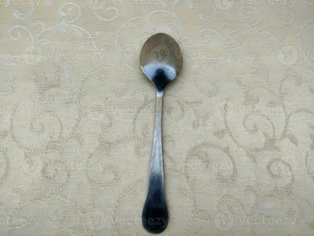 several aluminum spoons arranged uniquely on the table photo