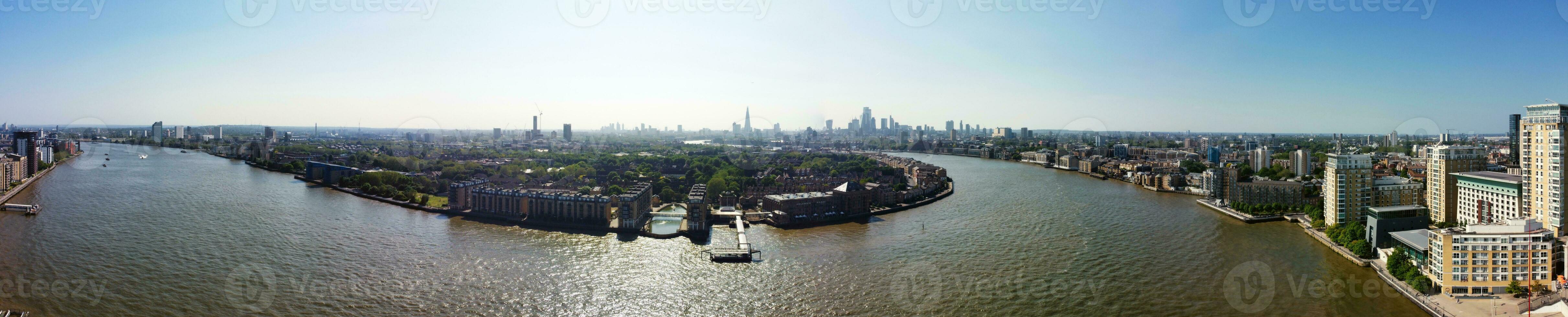High Angle Panoramic View of Canary Wharf Buildings at Central London City of England Great Britain. The Footage Was Captured with Drone's Camera at Low Altitude on 08-June-2023 During Sunset. photo