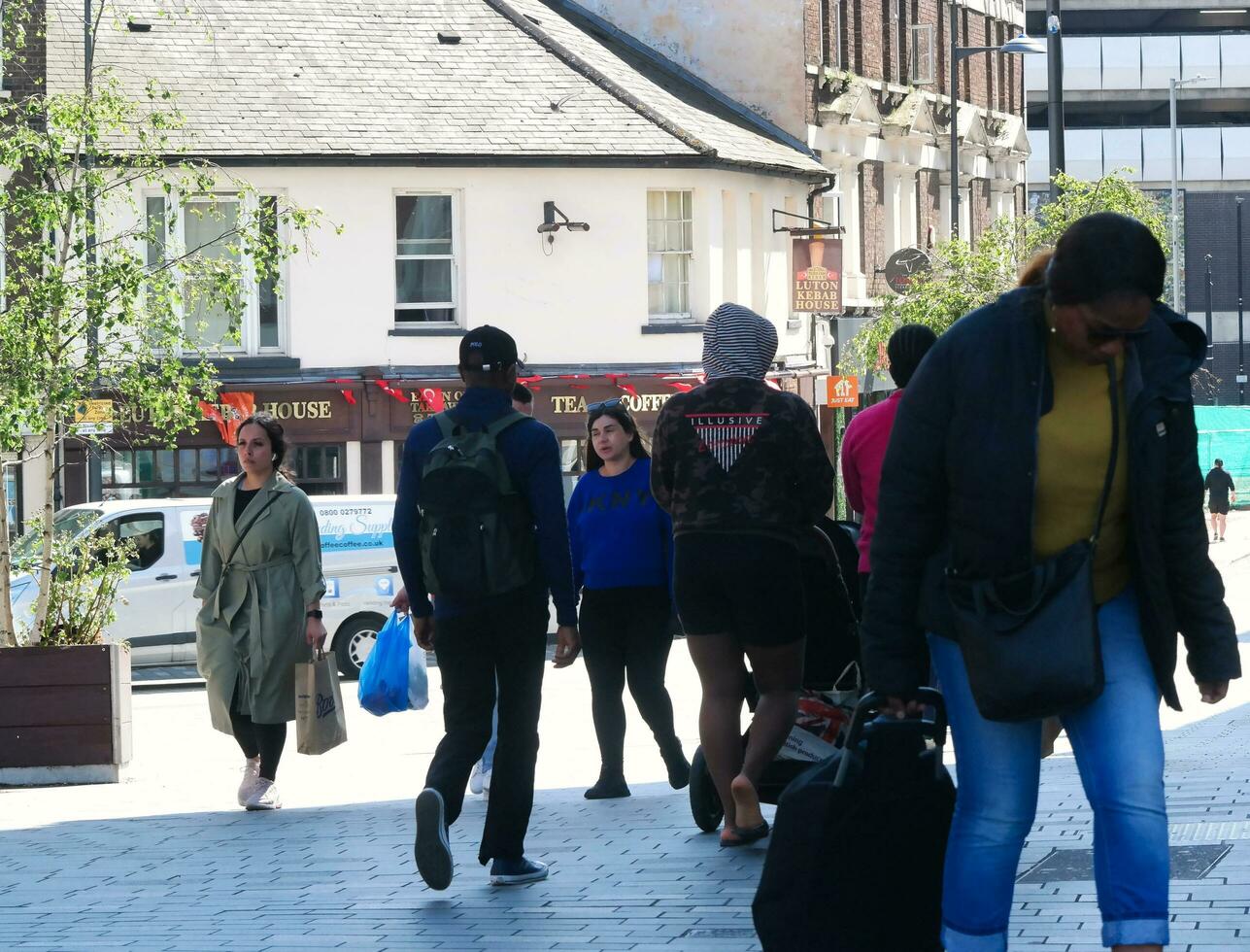Beautiful Image of People at The Mall Shopping Centre Downtown of Central Luton City of England Great Britain for Shopping and Walking. The Image Was Captured on 02-June 2023 photo