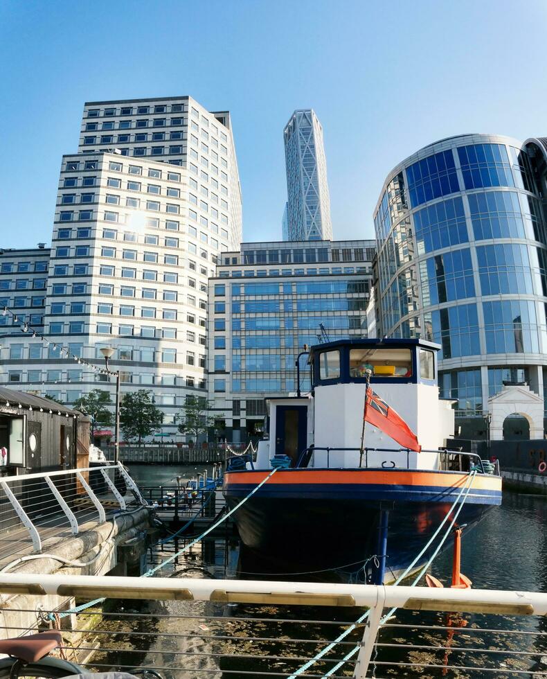 Low Angle Panoramic View of Canary Wharf Central London City with Tall Buildings, Road, People at Most Expensive Area of London City of England UK. The Footage Was Captured on 08-June-2023 photo