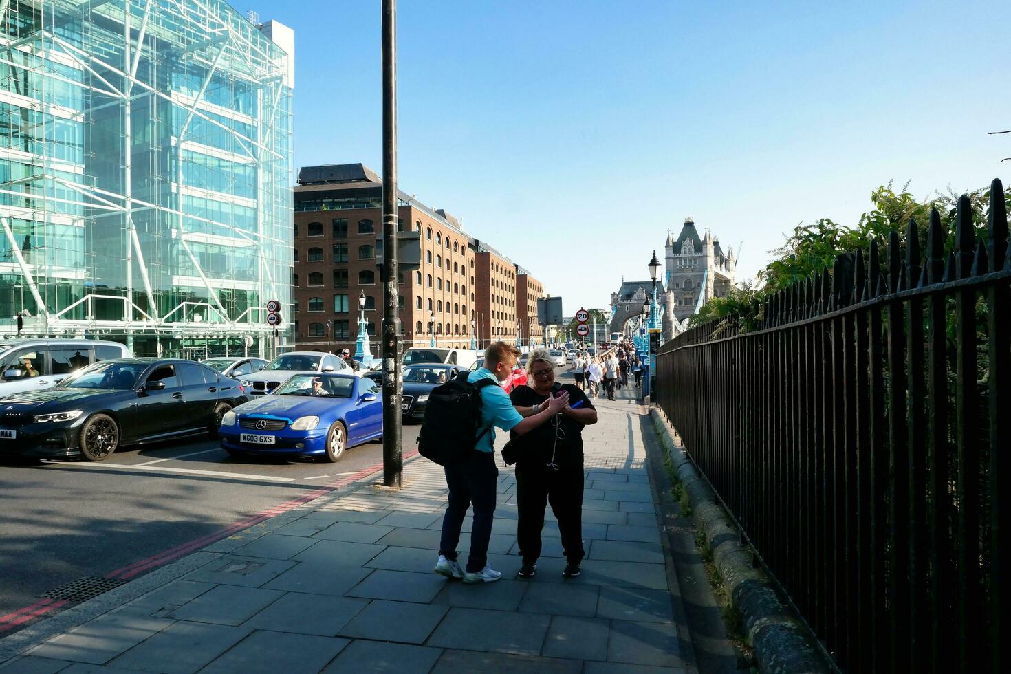 Beautiful Low Angle View of Central London and Road with Traffic and People. The Image Was Captured at Tower Bridge London England Great Britain on Warm Sunny Day of 04-June-2023 photo