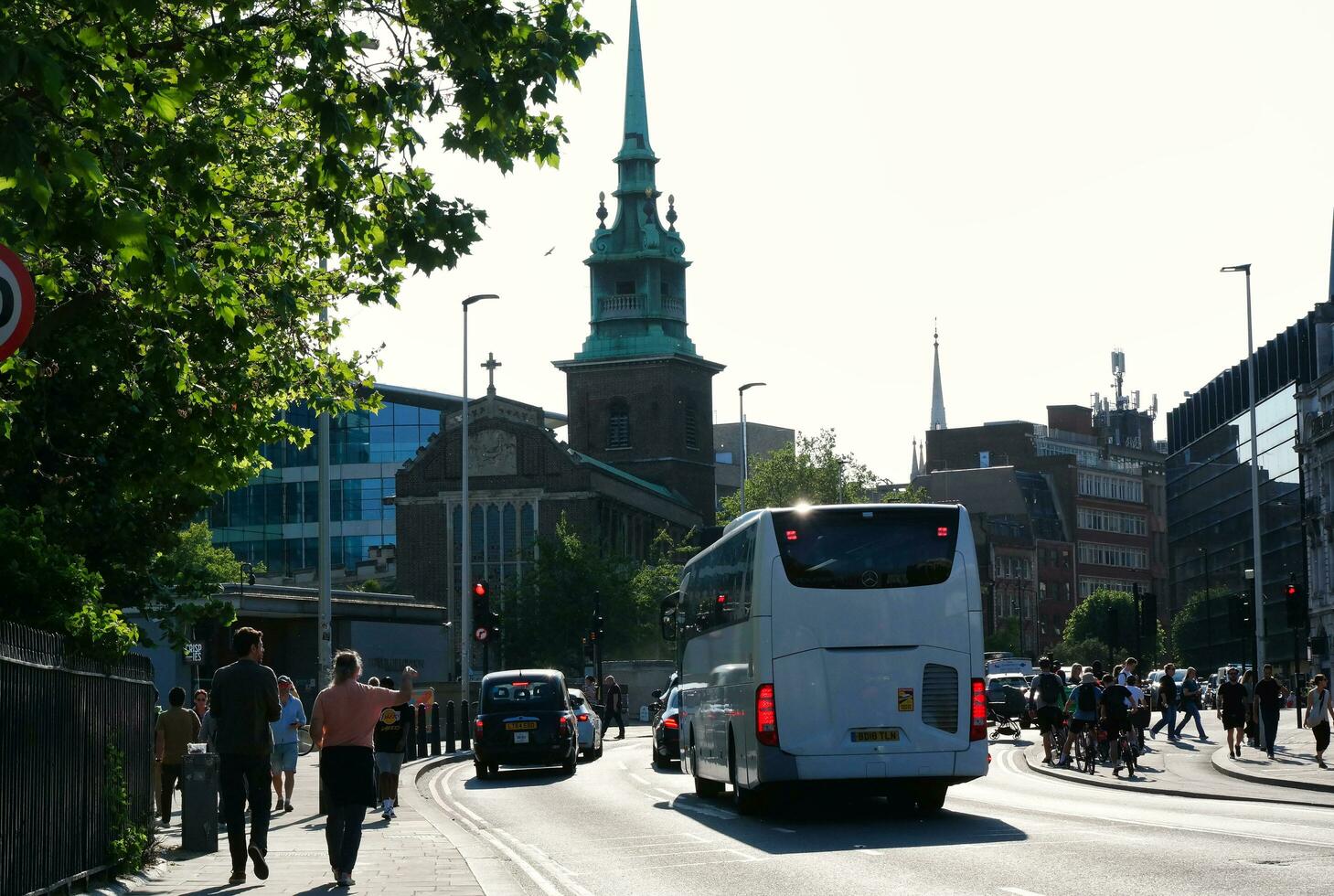 Beautiful Low Angle View of Central London and Road with Traffic and People. The Image Was Captured at Tower Bridge London England Great Britain on Warm Sunny Day of 04-June-2023 photo