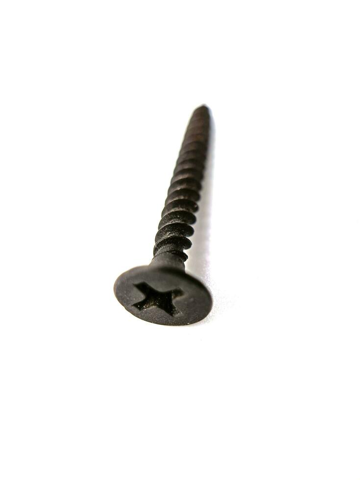 Tapping screws made of steel on Gray background, metal screw, iron screw, chrome screw, screws as a background, wood screw, concept industry. photo