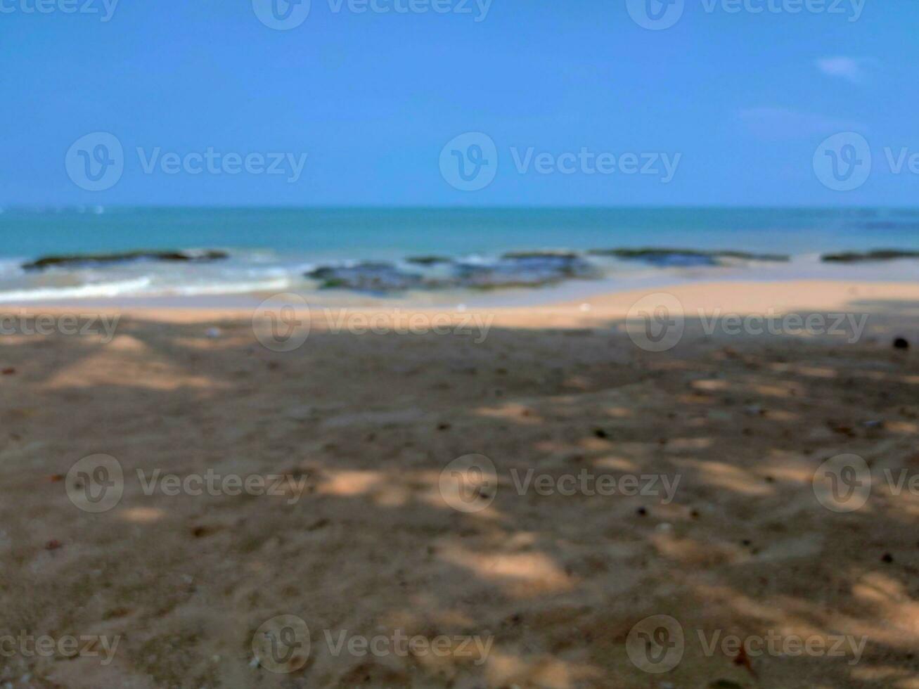Beachside blur background view, white beach with bright blue sky background photo