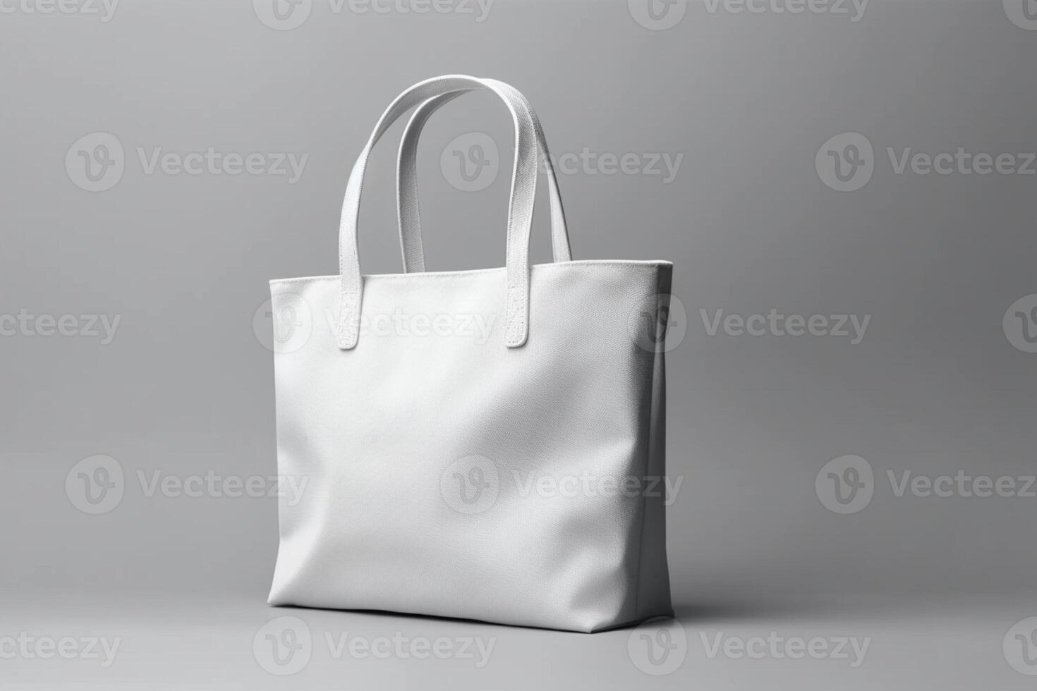 Minimalist white mock-up tote on a neutral gray surface photo