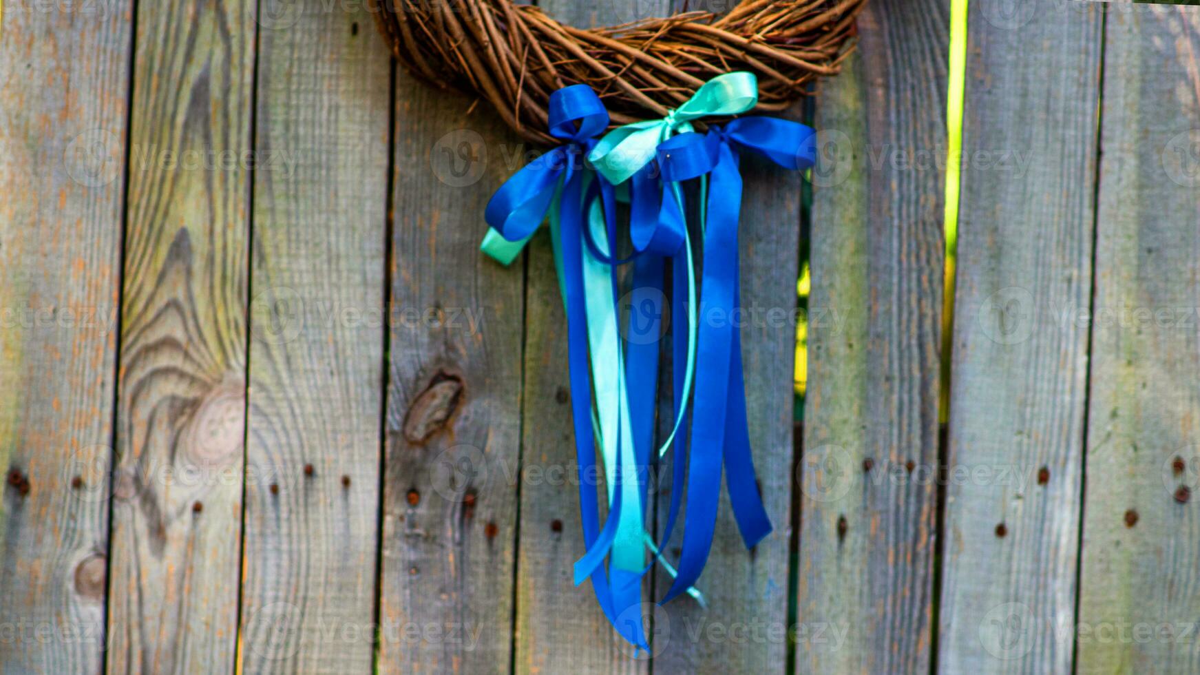 Beautiful autumnal wreath with strips on wooden background, top view. Space for text photo