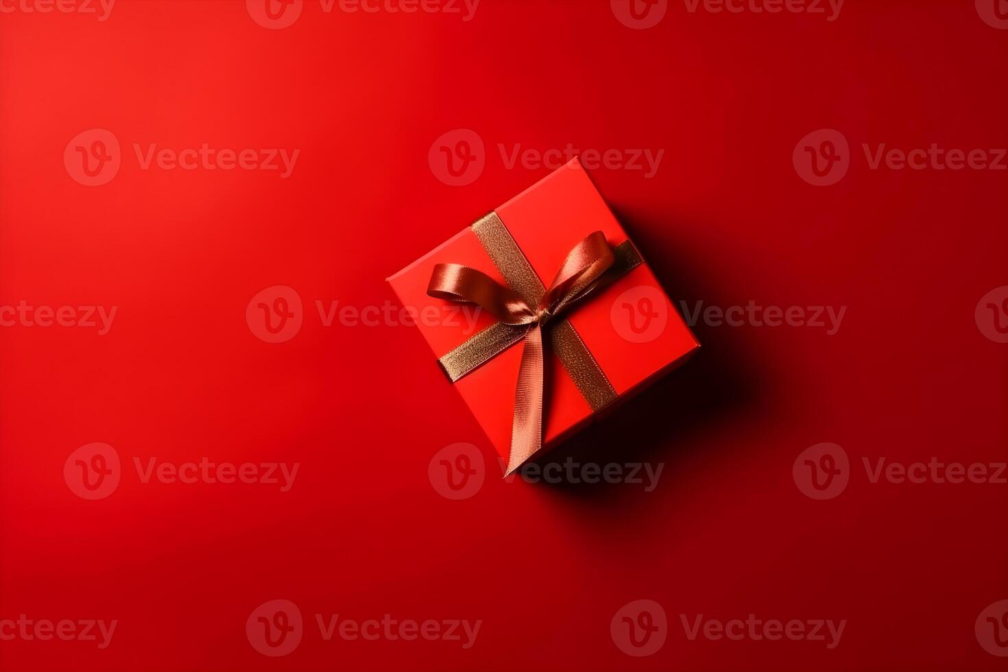 Red gift box with red ribbon on red background with copy space. photo