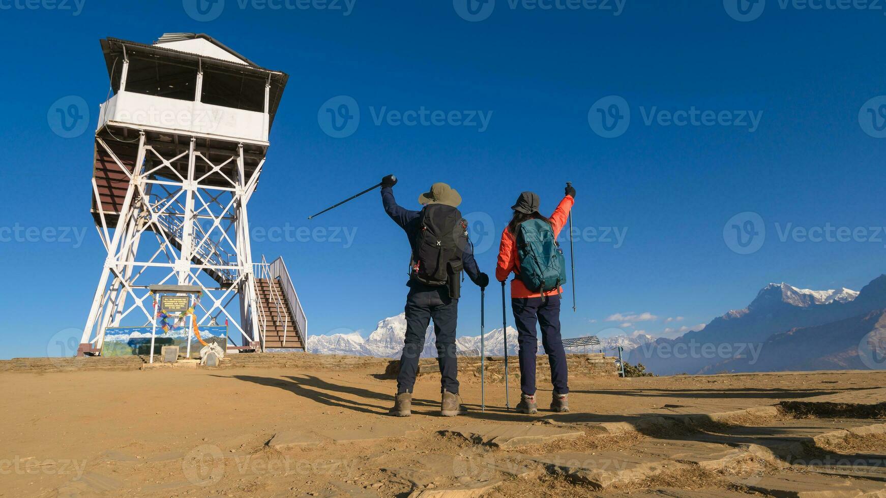 A young couple travellers trekking in Poon Hill view point in Ghorepani, Nepal photo