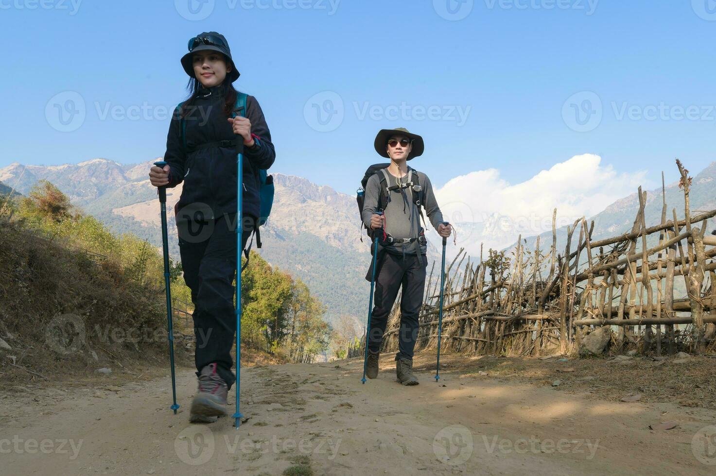 A young couple travellers trekking in Poon Hill view point in Ghorepani, Nepal photo