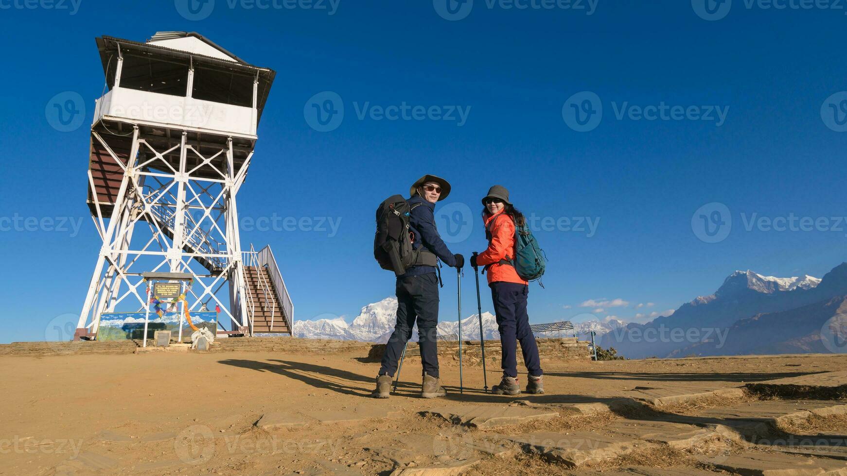 A young couple travellers trekking in Poon Hill view point in Ghorepani, Nepal photo